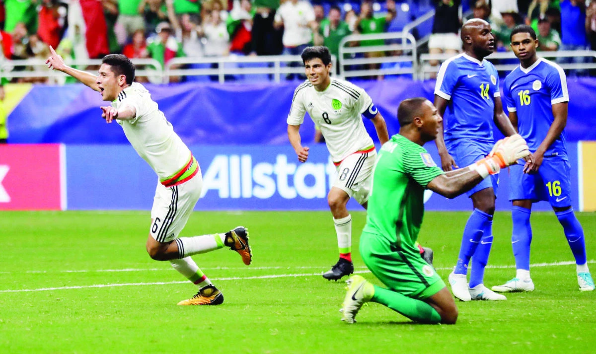 Mexico’s Edson Alvarez, left, celebrates his goal against Curacao during a CONCACAF Gold Cup soccer match Sunday. (AP)
