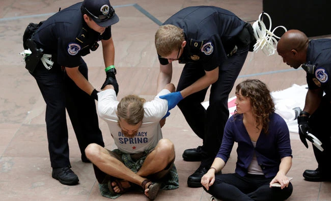 Healthcare activists are detained after a protest to stop the Republican health care bill at Hart Senate Office Building on Capitol Hill in Washington, D.C. on Monday. (REUTERS/Yuri Gripas)