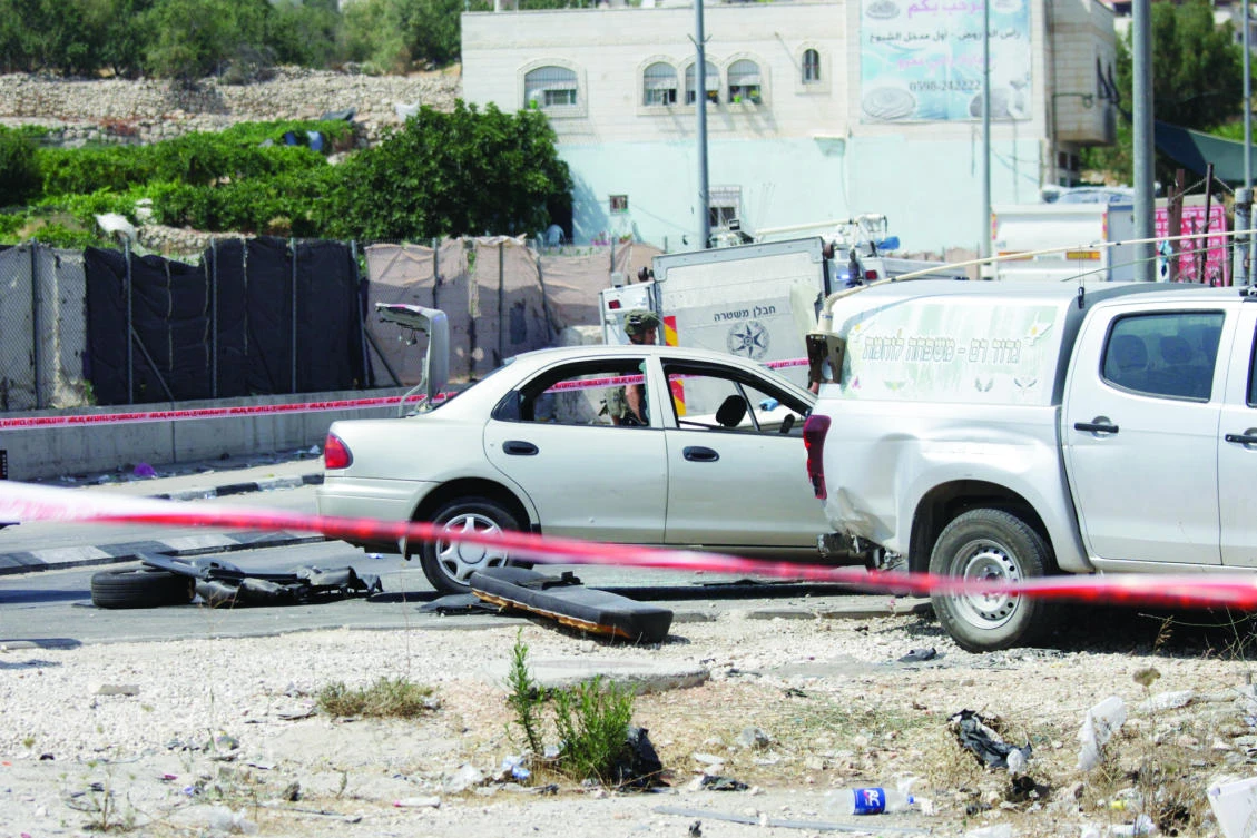 An Israeli soldier is seen at the scene of an attack near Hebron on Tuesday. (AP)