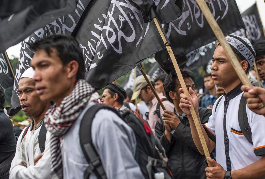 Indonesian Muslims wave Hizbut Tahrir's flag 'ar rayah' during an anti-government rally in Jakarta on Tuesday. (AFP)