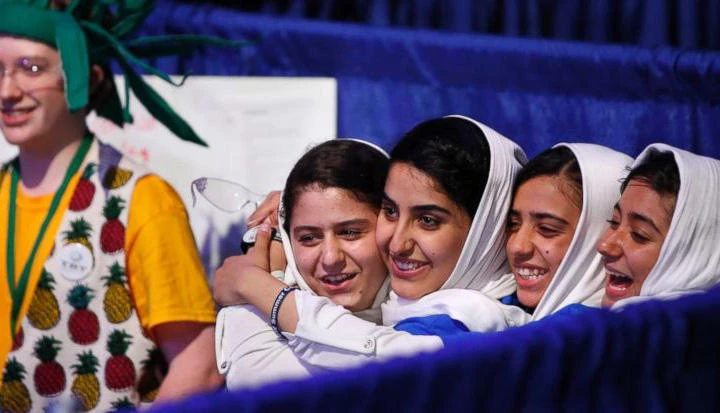 Team Afghanistan, from second from left, Kawsar Rashan, Lida Azizi, Somayeh Faruqi, and Rodaba Noori, next to a member of Team Australia, left, hug before their final round of competition at the FIRST Global Robotics Challenge, Tuesday, July 18, 2017, in Washington. The challenge is an international robotics event with teams from over 100 countries. (AP)