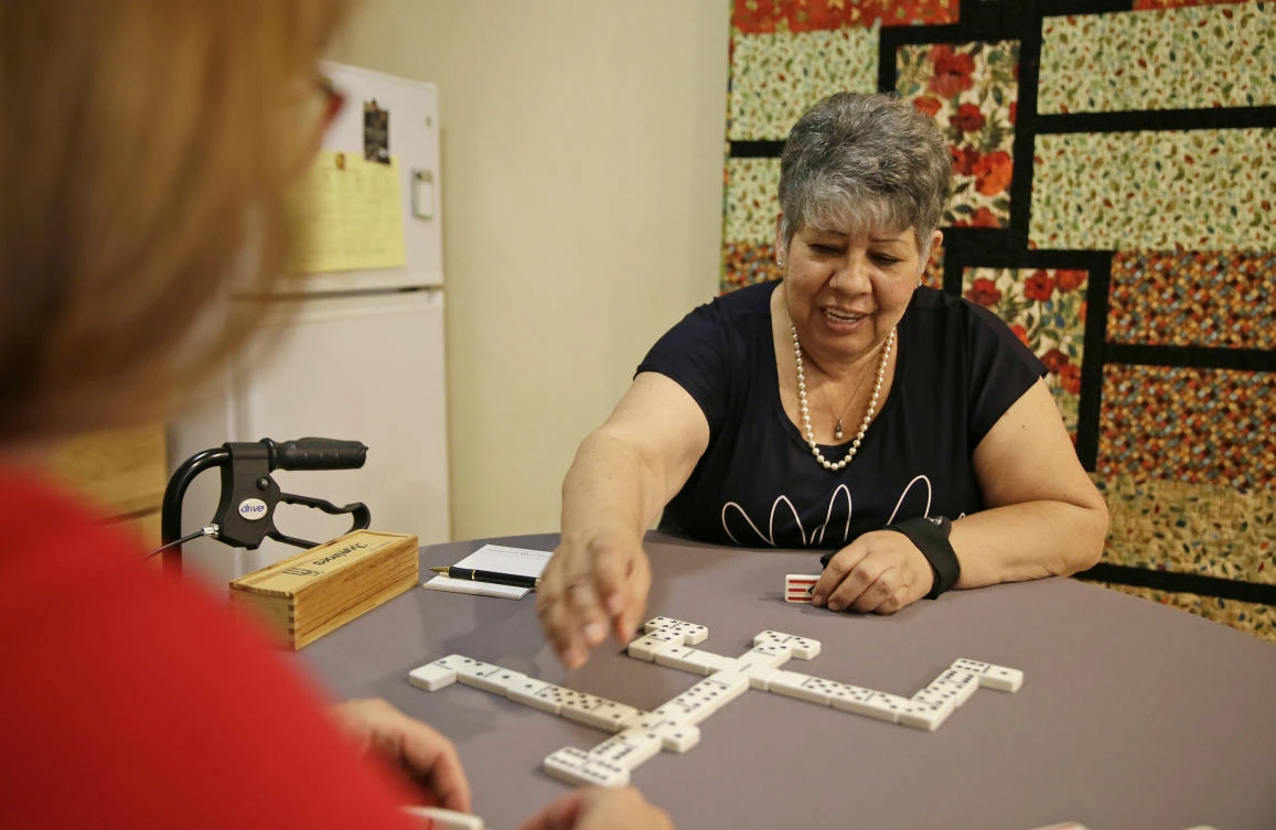 In this photo taken July 12, 2017, Cynthia Guzman plays dominoes at her home in Napa, Calif. Guzman underwent a special kind of PET scan that can detect a hallmark of Alzheimer’s and learned she didn’t have that disease as doctors originally thought, but a different form of dementia. New research suggests those scans may lead to changes in care for people with memory problems that are hard to diagnose. (AP)