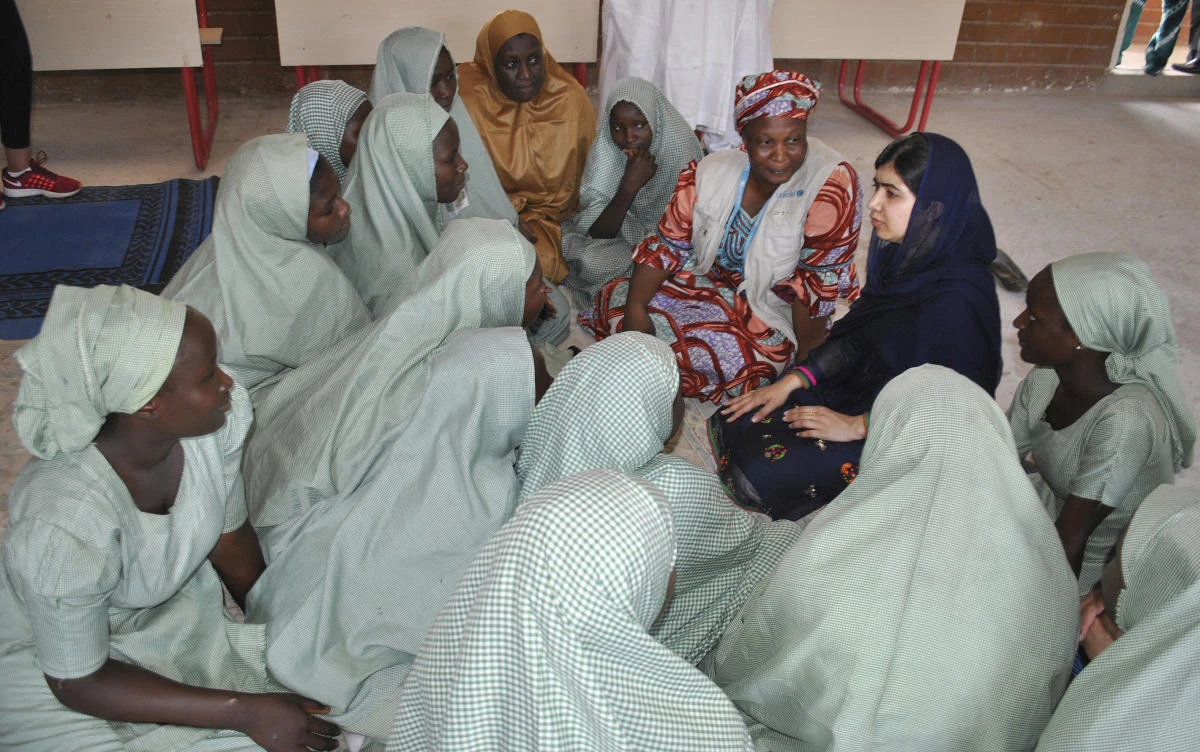 Pakistani activist Malala Yousafzai, center right, speaks with school girls in Maiduguri, Nigeria on Tuesday. (AP)