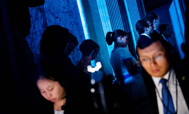 Chinese interpreters and others listen during a US and China comprehensive Economic Dialogue at the US Department of the Treasury on Wednesday in Washington, DC. After riding a wave of anti-trade feeling to the White House, the Trump administration is taking a more traditional approach to resolving issues with China. (AFP)