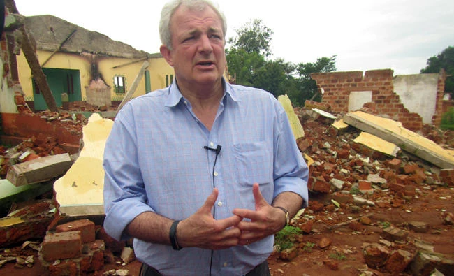 U.N. humanitarian chief Stephen O'Brien answers reporters' questions during an organized trip to Bangassou, Central African Republic on July 18, 2017. O'Brien insisted that the U.N. is there to help, and he warned of the growing violence. More than 300 people have been killed and 150,000 displaced since mid-May as violence that began in 2013 moves into the impoverished country's central and southeastern regions. (AP Photo/Hyppolite Marboua)