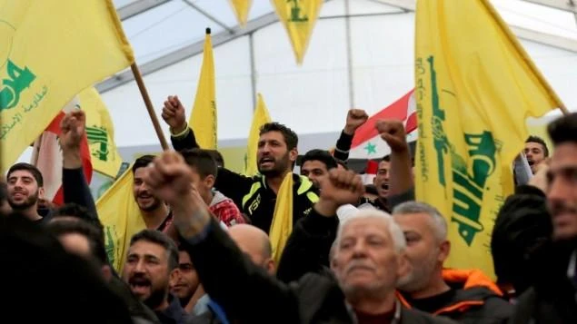 Supporters of Hezbollah chant slogans during a televised speech by leader Hassan Nasrallah in the southern town of Insar, Lebanon, on March 6, 2016. (AFP)