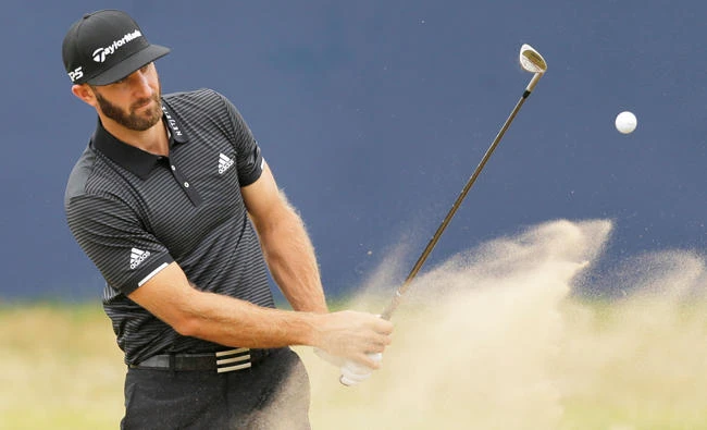 World No. 1 Dustin Johnson of the US plays out of the bunker on the 18th hole during a practice round ahead of the British Open Golf Championship, at Royal Birkdale,
Southport, England. (AP)