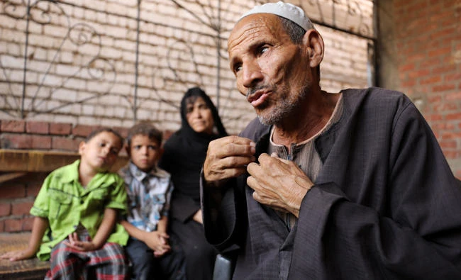Abdallah Mahmoud, father of Youssef Abdullah, one of at least 22 Egyptians found dead earlier this month, perishing from heat and starvation after trekking the Libyan desert by foot, speaks in the village of Tarfa al-Kom in Minya province, Egypt, on July 12, 2017. (REUTERS/Mohamed Abd El Ghany)