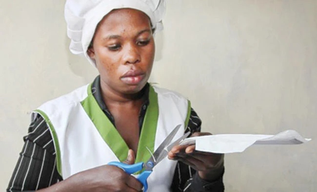 A worker cuts locally made sanitary pads known as Makapads, made from waste paper with papyrus as the absorbent, that sell for half the price of imported pads, at a factory in Kampala, Uganda in this July 17 photo. (AP)