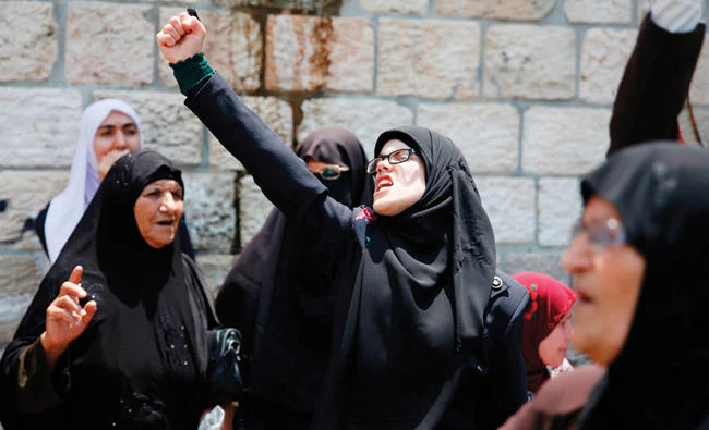 Palestinian protesters shout slogans during a demonstration in Jerusalem’s Old City on Thursday. (AFP)