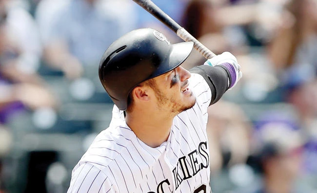 Nolan Arenado of the Colorado Rockies hits a home run in the fourth inning against the San Diego Padres at Coors Field on Wednesday in Denver, Colorado. (AFP)