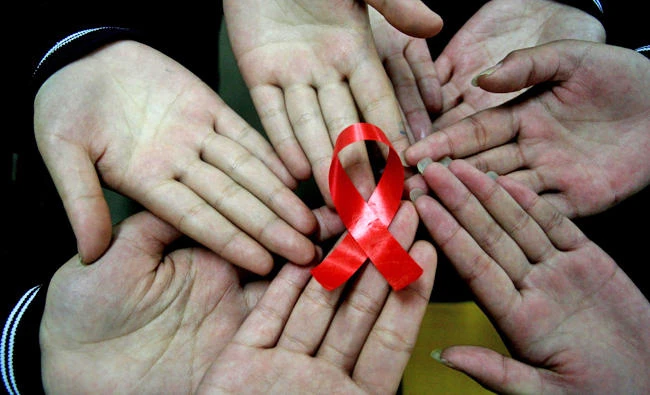 Chinese students showing a handmade red ribbon one day ahead of the the World AIDS Day, at a school in Hanshan, east China's Anhui province. Some 6,000 global HIV experts gather in Paris from July 23, 2017 to take stock of advances in AIDS science as fading hopes of unlocking a cure has shifted research into creative new fields. (AFP)