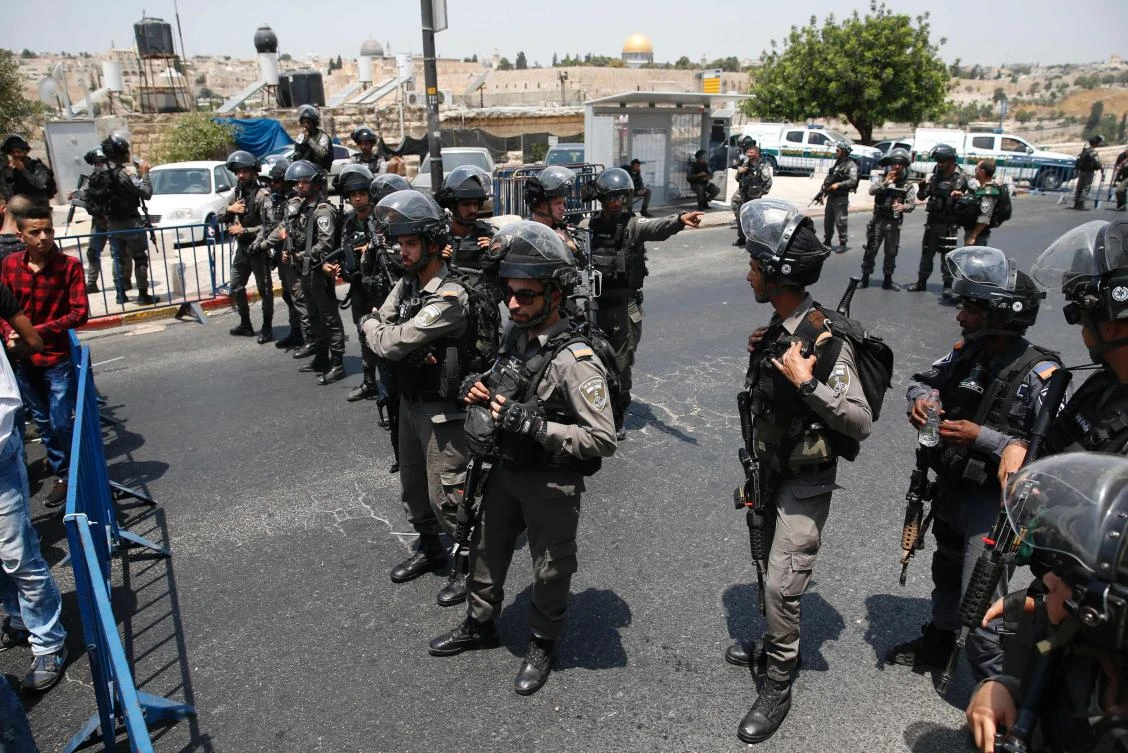 Israeli security forces stand guard on the outskirts of Jerusalem's Old City after Israeli police barred men under 50 from entering the Old City for Friday Muslim prayers as tensions rose and protests erupted over new security measures at a highly sensitive holy site on July 21, 2017. The rare ban came after Israeli ministers decided not to order the removal of metal detectors erected at entrances to the Haram al-Sharif mosque compound, known to Jews as the Temple Mount, following an attack nearby a week ago that killed two policemen. (AFP)