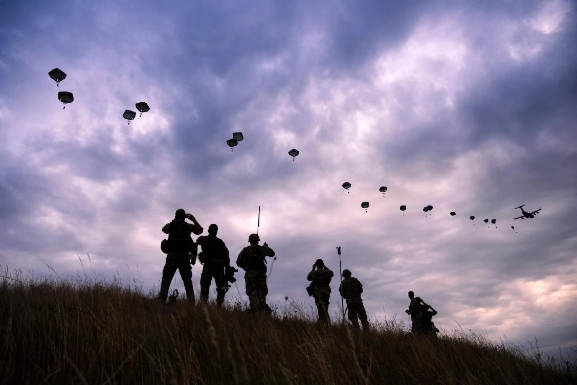 TOPSHOT - NATO paratroopers drop out of a US Air Force Hercules during the 'Swift Response 17' joint airborn military exercise at Bezmer airfield near the village of Bezmer on July 18, 2017. The US led 'Swift Response 17' airborne exercise, part of the multinational 'Saber Guardian 2017' exercise, involves up to 1,600 soldiers from the United States, Canada, Italy, Portugal and Greece. / AFP / Dimitar DILKOFF