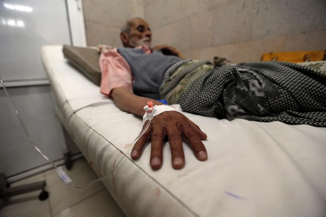 A Yemeni man suspected of being infected with cholera receives treatment at a makeshift hospital in Sanaa. (AFP)