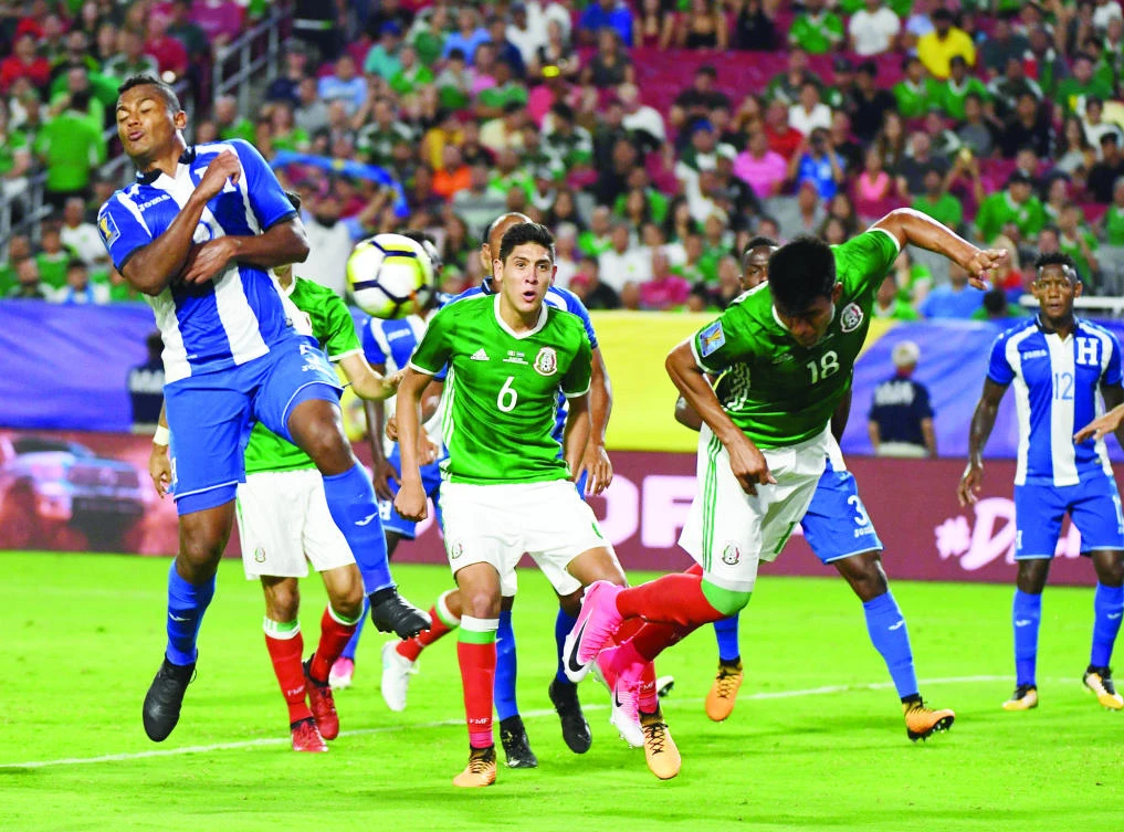 Mexico’s Jesus Gallardo, right, defends against Ever Alvarado from Honduras, left, during their quarterfinal CONCACAF Gold Cup match at the University of Phoenix Stadium in Glendale, Arizona, on Thursday night. (AFP)