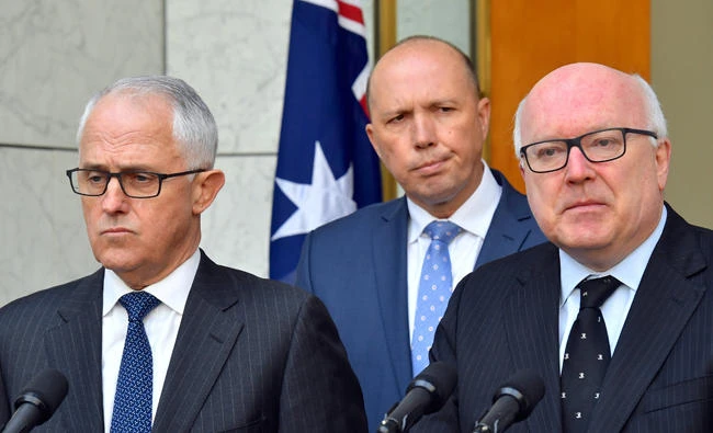 Australia's Attorney-General George Brandis, Australian Minister for Immigration Peter Dutton and Prime Minister Malcolm Turnbull attend a media conference at Parliament House in Canberra, Australia, on July 18, 2017. (AAP/Mick Tsikas/via REUTERS)