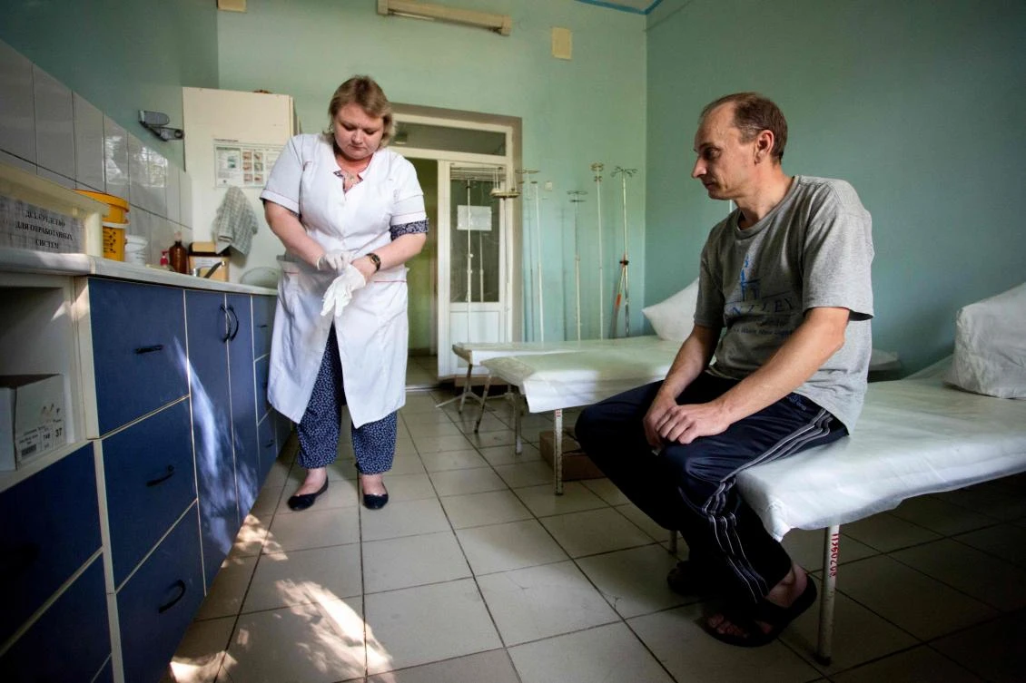 A patient waits to be treated in the toxicology unit in a hospital treating drug users in the rebel capital of Donetsk on July 11, 2017. Prior to the start of the conflict in April 2014, ex-Soviet Ukraine -- especially in its eastern regions of Donetsk and Lugansk -- was already battling against one of the most severe HIV epidemics in Eastern Europe. In 2015 international actors managed to stave off an imminent disaster by negotiating with Kiev and the rebels to keep supplying antiretroviral drugs to thousands of HIV positive people in the separatist territories. Emergency funds were provided and the United Nations now estimates that about 10,000 adults and children with HIV in rebel-held areas are receiving the drugs. (AFP)