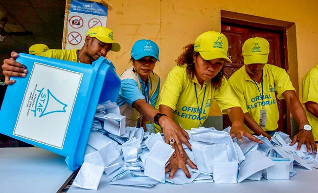 Election officials open a ballot box during counting for the parliamentary election in Dili on Saturday. (AFP)