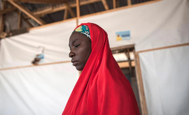 A woman leaves a consultation at the IRC (International Rescue Committee) health clinic in Bakassi IDP (Internally Displaced People) Camp in Maiduguri in north-east Nigeria on July 7, 2017. (AFP)