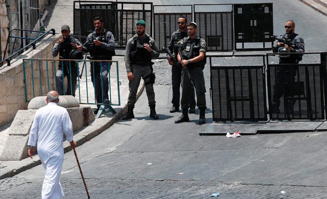 Israeli security forces stand guard outside Lions’ Gate, a main entrance to the Al-Aqsa mosque compound in Jerusalem’s Old City on Saturday. (AFP)