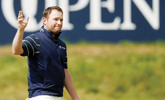 South Africa’s Branden Grace acknowledges the crowd on the 18th hole Saturday after completing his third round at the 146th Open Championship and scoring the lowest ever round in a major championship. (Reuters)
