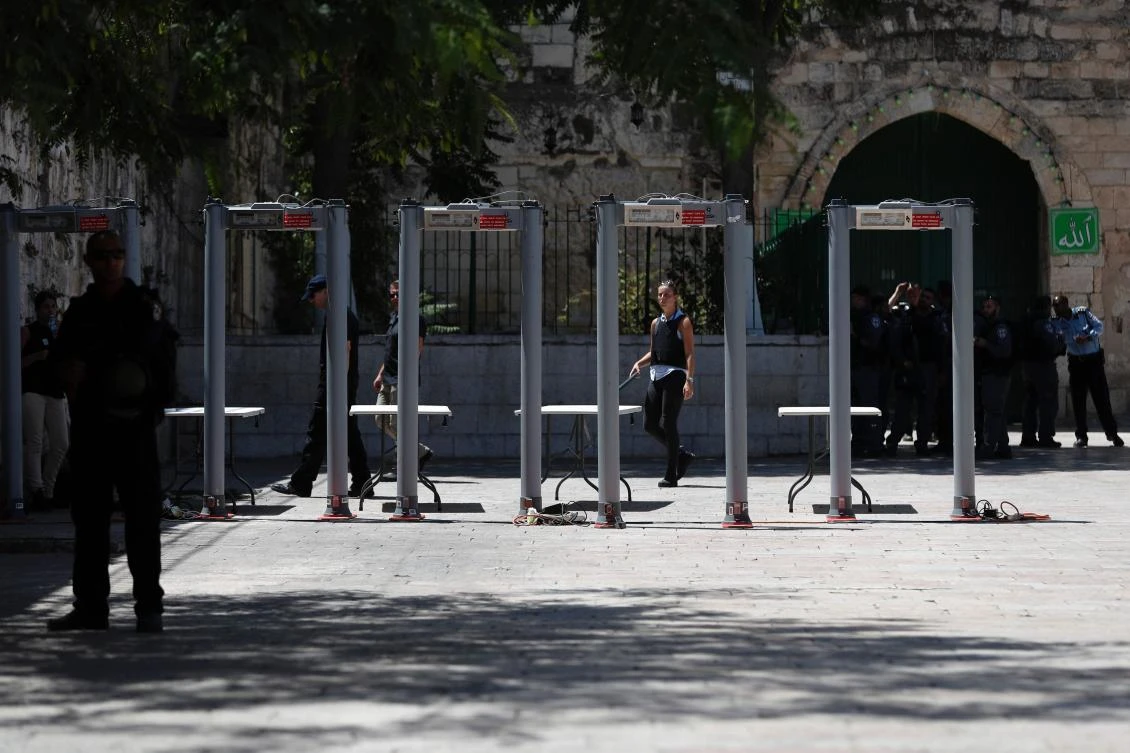 Israeli border policemen install metal detectors outside the Lion's Gate, a main entrance to Al-Aqsa mosque compound, in Jerusalem's Old City, on July 16, 2017, after security forces reopened the ultra-sensitive site, whose closure after a deadly attack earlier in the week sparked anger from Muslims and Jordan, the holy site's custodian. Three Arab Israeli assailants opened fire on Israeli police on July 14 in the Old City, killing two of them before fleeing to the nearby Haram al-Sharif compound, where they were shot dead by police. (AFP)