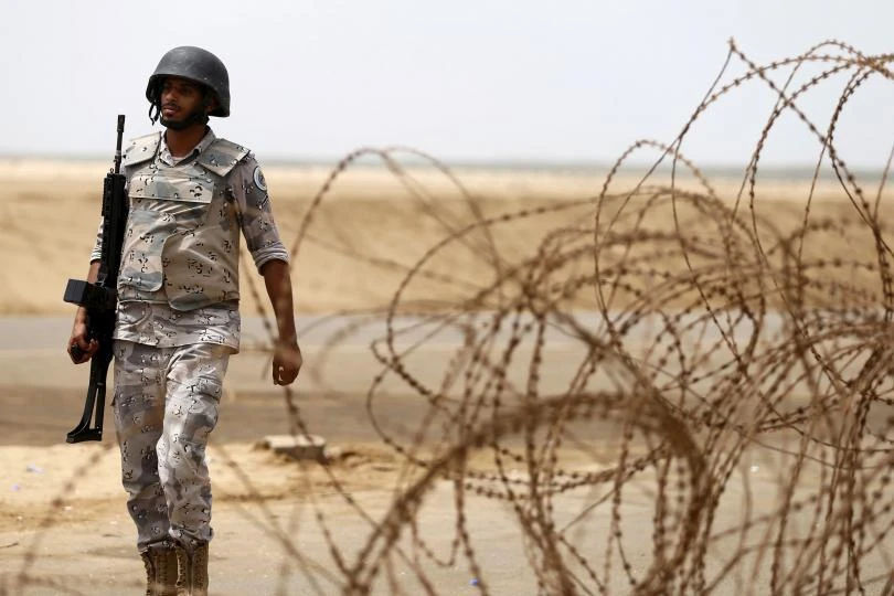 A Saudi soldier walks along Saudi Arabia's border with Yemen. (REUTERS)