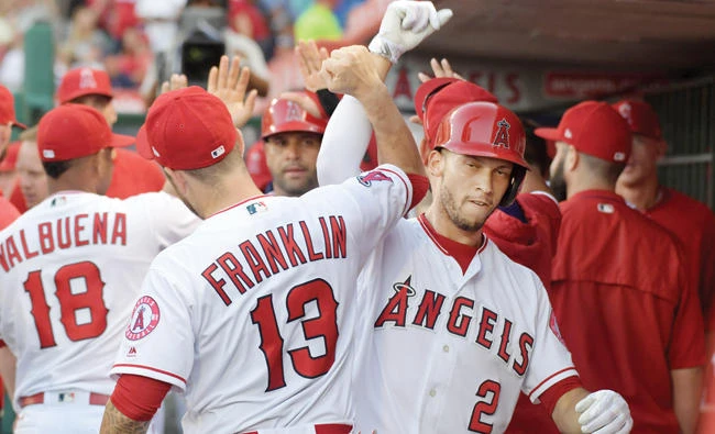 Los Angeles Angels shortstop Andrelton Simmons (2) celebrates with left fielder Nick Franklin after hitting a two-run home run in the third inning against the Boston Red Sox at Angel Stadium of Anaheim on Saturday. (USA TODAY Sports)