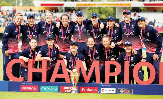 England players pose with their medals and the champion trophy. (Reuters_