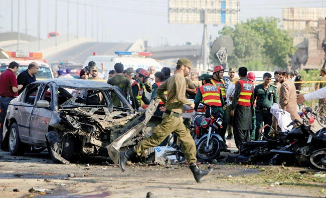 Rescue workers and policemen gather after a suicide blast in Lahore, Pakistan on Monday. (Reuters)