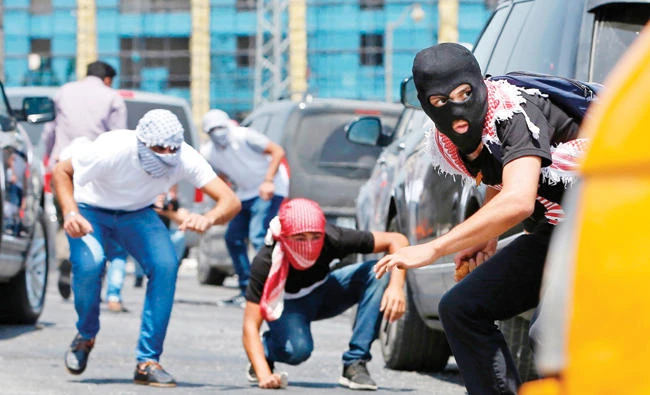 Palestinian protesters clash with Israeli security forces on Monday near the Jewish settlement of Beit El, near the West Bank city of Ramallah. (AFP)