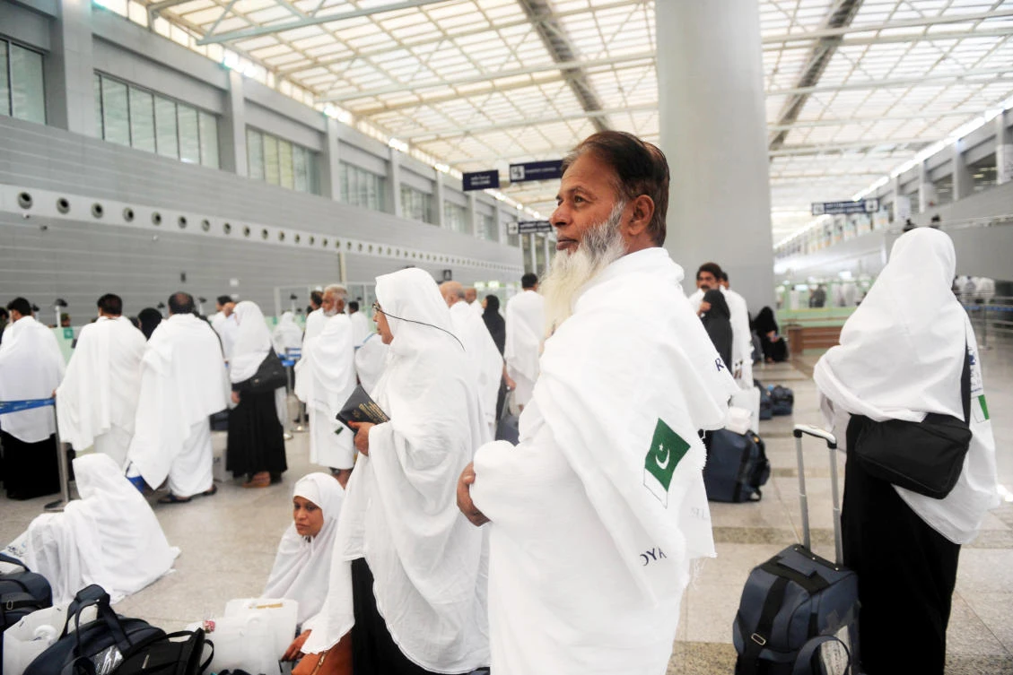 Pakistani pilgrims wait to pass security as the first group arrives in Jeddah on Monday. (AFP)