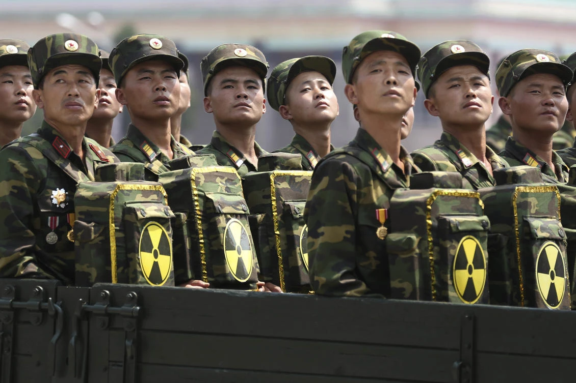 FILE - In this July 27, 2013, file photo, North Korean soldiers turn and look towards leader Kim Jong Un as they carry packs marked with the nuclear symbol during a military parade in Pyongyang, North Korea. North Korea’s nuclear and missile programs have without doubt come at a severe cost. Even so, the North has managed to march ever closer to having an arsenal capable of attacking targets in the region and _ as demonstrated by its July 4 ICBM test launch _ the United States’ mainland. (AP)