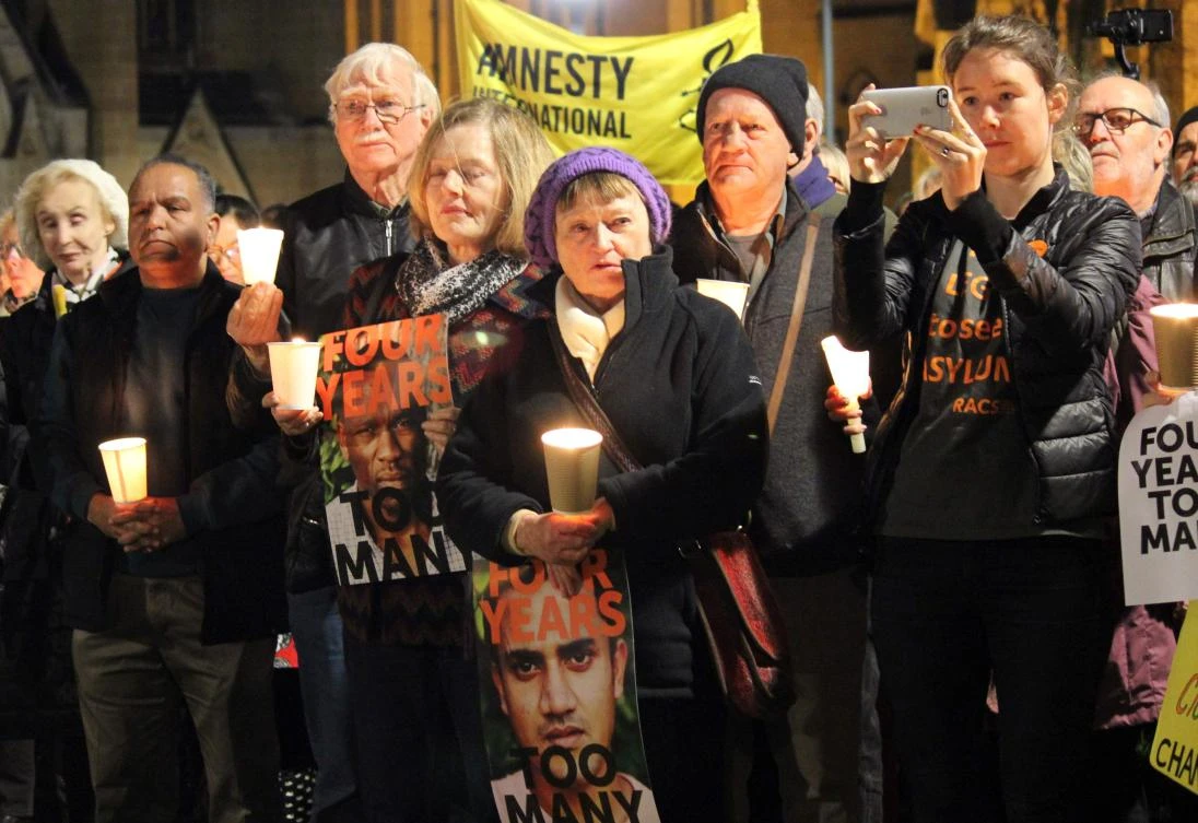 This picture provided by GetUp and taken by Adam Marsters on July 19, 2017 shows participants of a vigil holding placards to show solidarity with the refugees and asylum seekers in PNG and Nauru camps, in Sydney. Hundreds of refugees being held at a remote Papua New Guinea detention camp will be moved by October despite uncertainty over a resettlement deal with the United States, Australia's immigration minister said on July 20, 2017. (AFP)