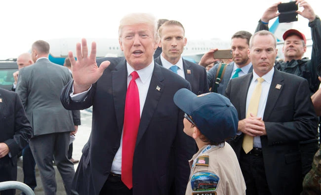 US President Donald Trump greets well wishers upon arrival on Air Force One at Raleigh County Memorial Airport in Beaver, West Virginia, on Monday. (AFP)
