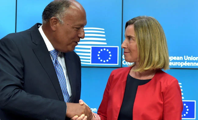 Federica Mogherini, EU foreign policy chief, with Sameh Hassan Shoukry, Egypt's foreign affairs minister, shake hands during Tuesday's news conference in Brussels, Belgium. (Reuters)