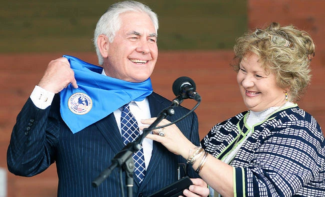 In this July 21, 2017, photo, U.S. Secretary of State Rex Tillerson holds up a Boy Scout scarf that his wife Brenda placed on him at the end of his talk at the Summit Bechtel Family National Scout Reserve in Glen Jean, W.Va. (AP)
