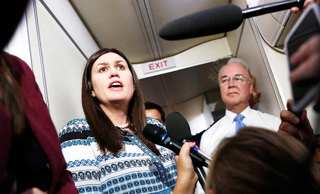 White House press secretary Sarah Huckabee Sanders, joined by Secretary of Health and Human Services Tom Price, speaks to media aboard Air Force One, on Monday, in Andrews Air Force Base, Md., en route to the 2017 National Scout Jamboree in Glen Jean, W.Va. (AP)