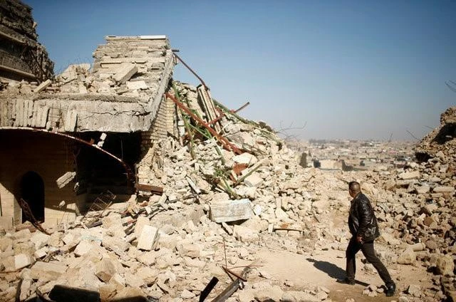 FILE PHOTO: An Iraqi man walks past a destroyed tomb of the Prophet Jonah (Nabi Younes) in the eastern side of Mosul, Iraq March 9, 2017. (REUTERS)