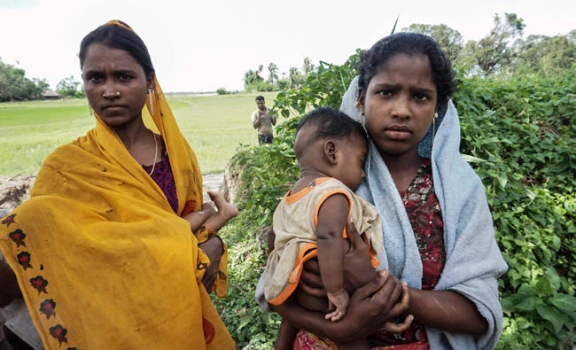 Ayamar Bagon, 20, left, and Hasamithaya 18, right, who claim to be raped by soldiers in December last year, holding their children in Kyar Gaung Taung village in Maungdaw, Myanmar. (AFP)