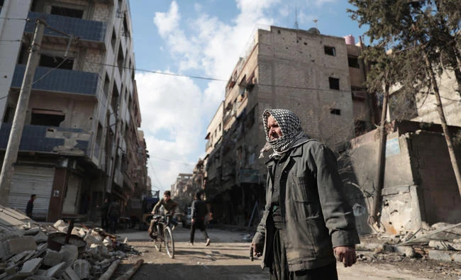 A Syrian looks at the rubble of his destroyed house in Douma, on the eastern outskirts of Damascus, in this file photo. (AFP)