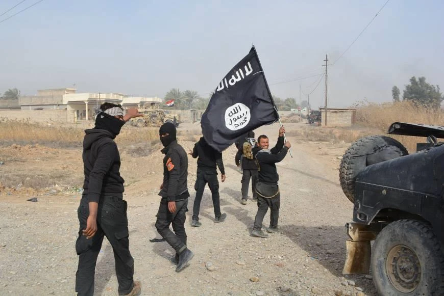 Iraqi government forces celebrate while holding an Islamic State flag after wresting control of Diyala province, northeast of Baghdad. (AFP)