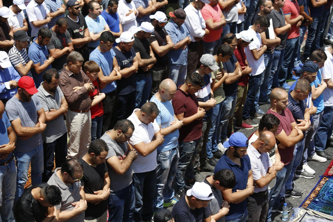 Palestinians pray outside Jerusalem’s Old City Friday, July 28, 2017. Muslim prayers at a major Jerusalem shrine ended peacefully Israeli police said Friday as forces were on high alert following two weeks of violence over the sacred site, holy to both Muslims and Jews. (AP)