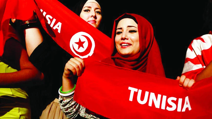 A file photo of demonstrators holding scarves outside the Constituent Assembly headquarters in Tunis. (Reuters)