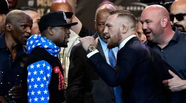 Floyd Mayweather Jr. (L) faces off for the first time with UFC fighter Conor McGregor during a press call at the Staples Center in Los Angeles, California on July 11, 2017. (AFP)