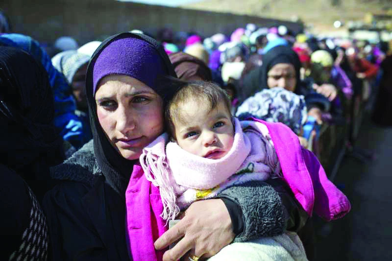 Newly arrived Syrian refugee women and children queue for registration and aid distribution in the town of Arsal, Lebanon, in this file photo of Feb. 17, 2014. (UNHCR)