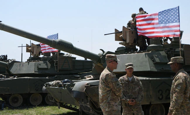 US soldiers stand by Abrams Battle Tanks bearing the US flag prior to the opening ceremony of the joint multinational military exercise 'Noble Partner 2017' at the military base of Vaziani, outside Tbilisi, on Sunday. (AFP)