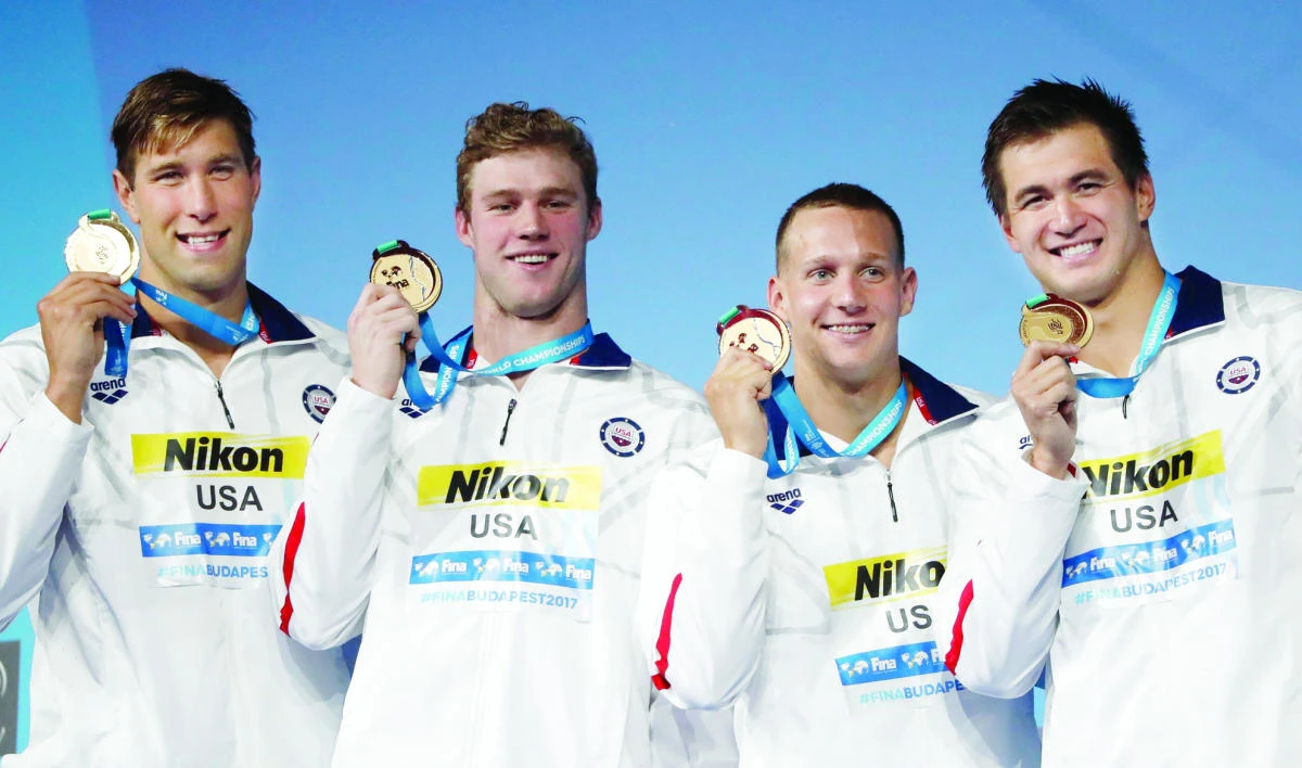 US gold medalists for the 4x100-meter medley relay Matt Grevers, Kevin Cordes, Caeleb Remel Dressel and Nathan Adrian celebrate on the podium Sunday. (Reuters)