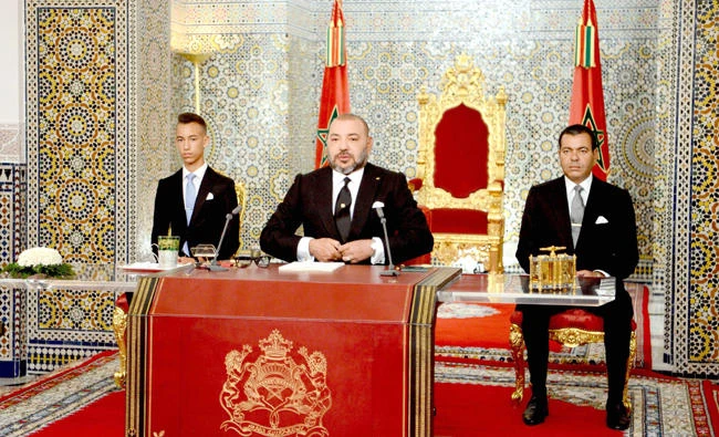 Morocco’s King Mohammed VI delivers a speech on Sunday to mark the 16th anniversary of his accession to the throne, flanked by his brother Prince Moulay Rachid, right,
and son Hassan III in Tetouan. (AFP)